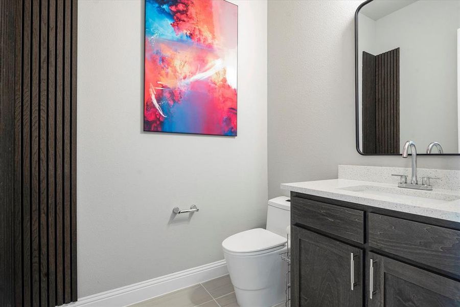 Bathroom with vanity, tile patterned flooring, and toilet