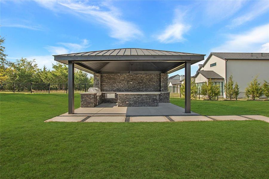 View of patio with area for grilling and a gazebo