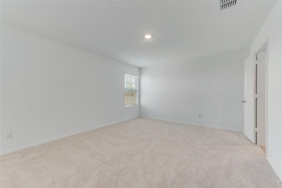 Empty room with light colored carpet