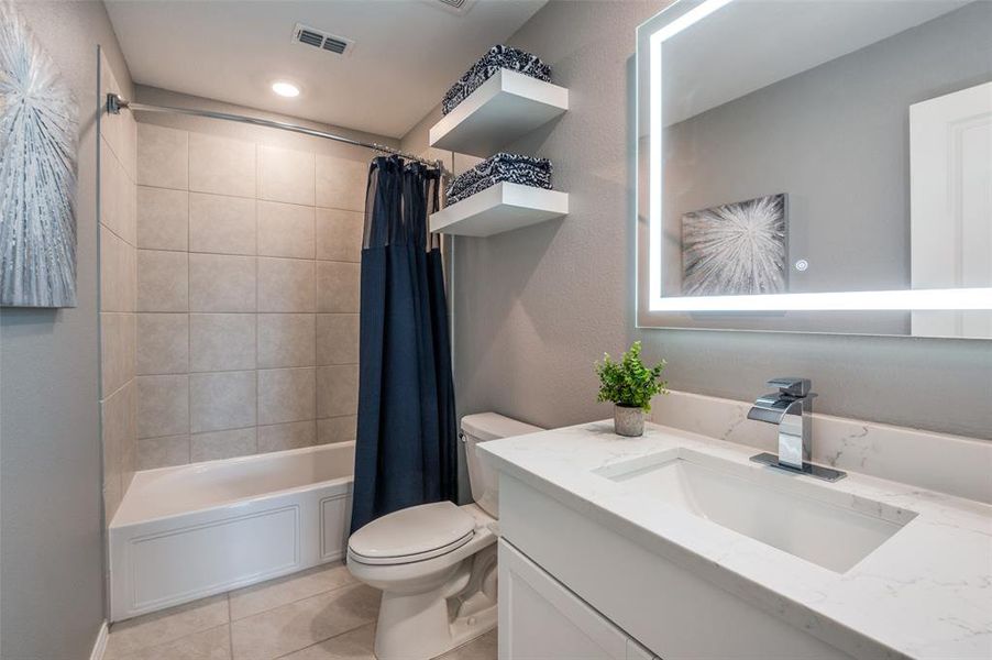 Floating shelves above lavatory are perfect towell storage.