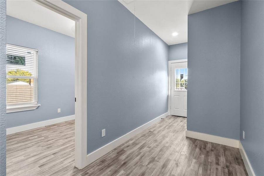 Empty room with a healthy amount of sunlight and light hardwood / wood-style flooring