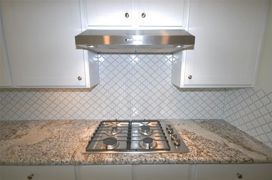 Quick and easy gas cooktop and externally vented hood.