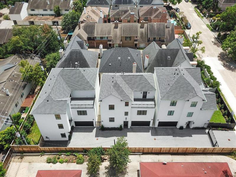 The aerial view reveals the unit's location at the community's edge, complete with side parking and an impressive backyard.