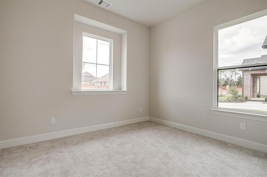 Carpeted empty room with plenty of natural light