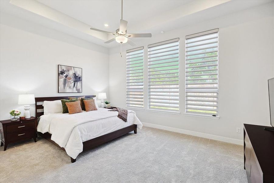 Carpeted bedroom with ceiling fan