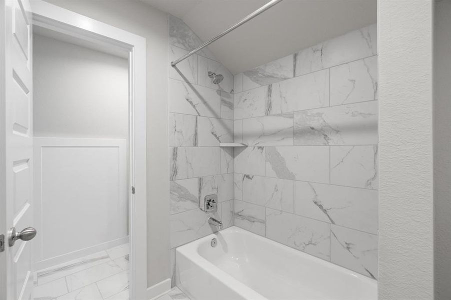 Bath/shower combo in this jack and jill bathroom. Sample photo of completed home with similar floor plan. As-built interior colors and selections may vary.