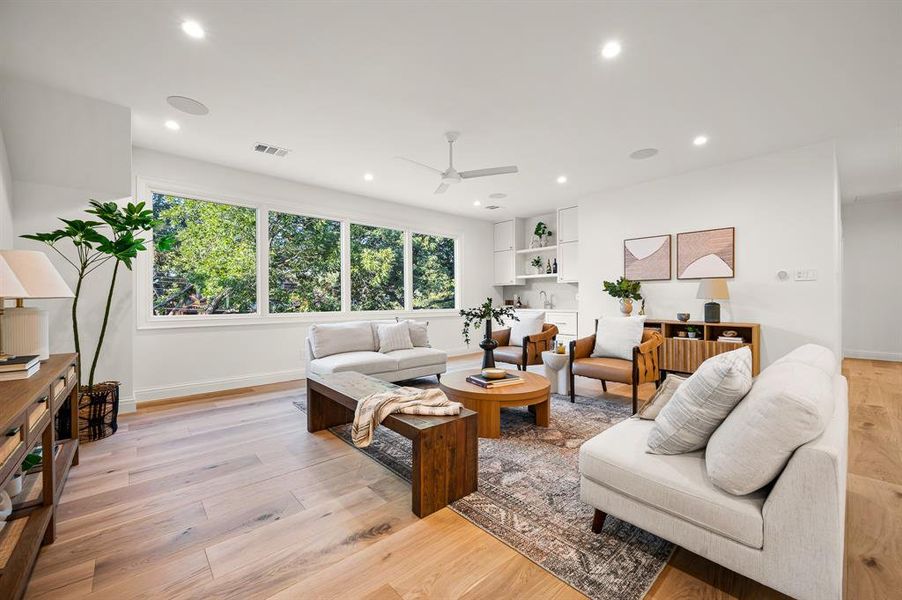 Living room featuring light hardwood / wood-style flooring and ceiling fan