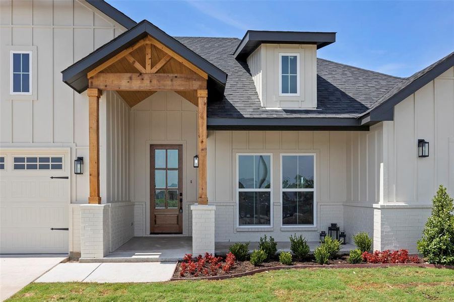 View of front of house with a garage and a front lawn