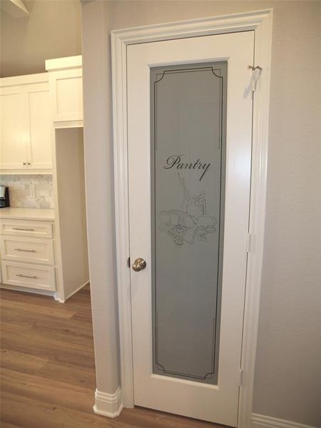 Details featuring hardwood / wood-style flooring and backsplash