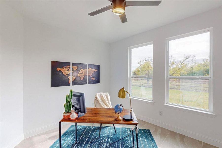 Office featuring light tile patterned floors and ceiling fan