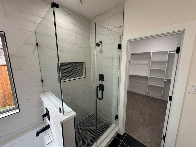 walk in shower and tile patterned floors