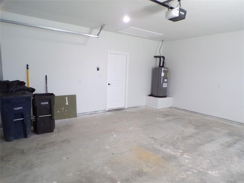 Garage with electric water heater and a garage door opener