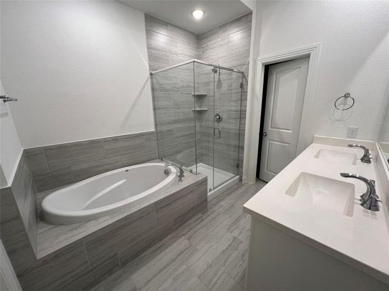 Bathroom featuring plus walk in shower and double vanity