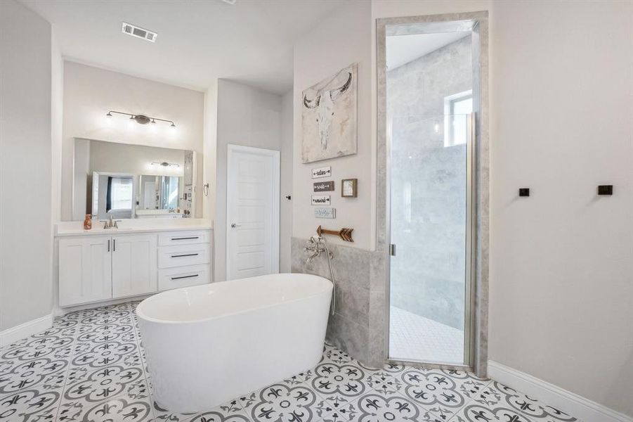 Bathroom featuring vanity, separate shower and tub, tile patterned flooring, and a wealth of natural light