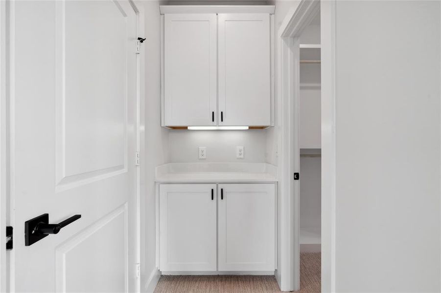 As you enter your walk-in closet you are greeted by your own custom cabinetry with under-mount lighting.