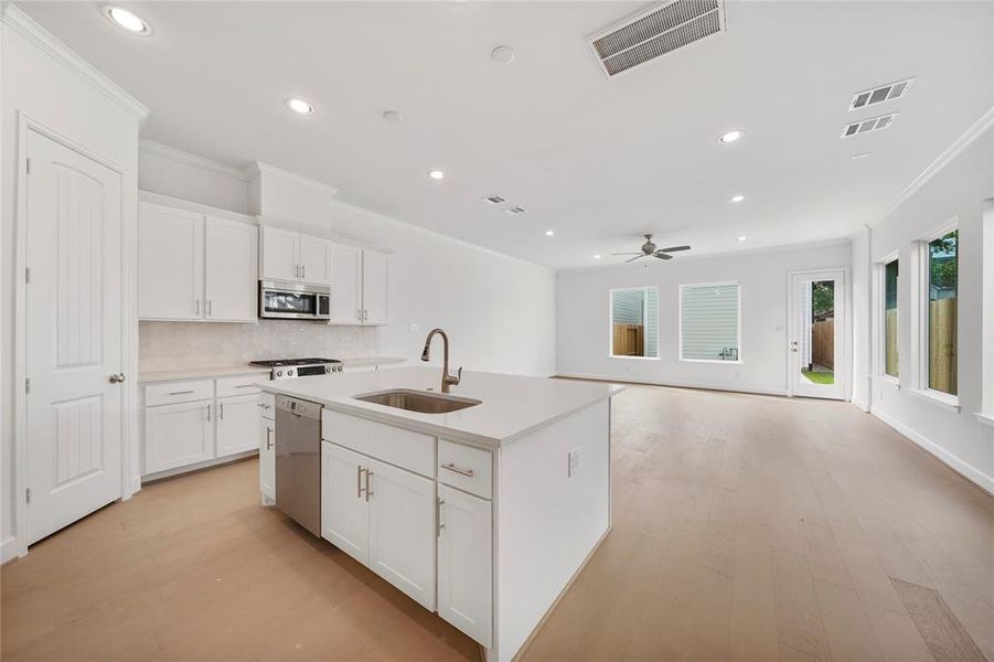 The kitchen is equipped with Stainless Steel LG Appliances (Microwave, Gas Range, Oven & Dishwasher). (Sample photos of a completed Gibraltar floor plan. The image may feature alternative selections and/or upgrades.)