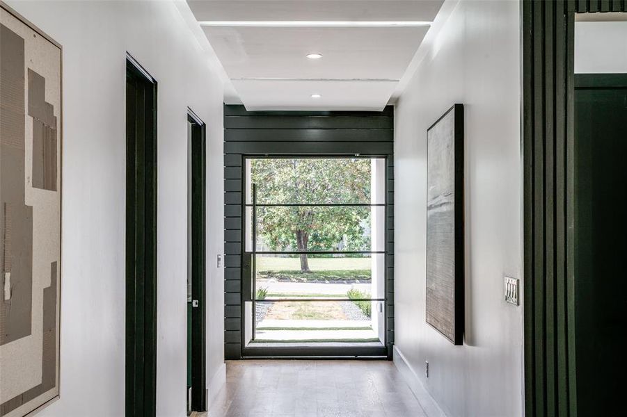 Doorway with wood-type flooring and plenty of natural light