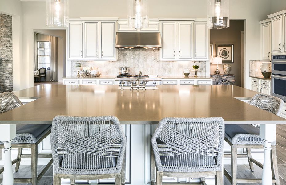 The over-sized kitchen island offers additional seating and extra space for cooking