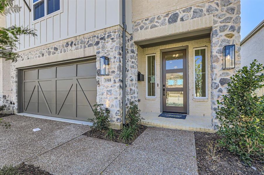 View of exterior entry with a garage