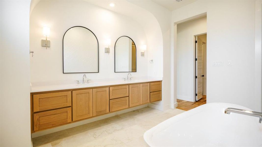 Bathroom featuring vanity and a washtub