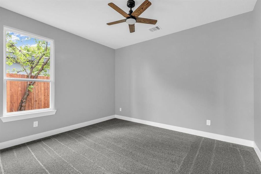 Spare room with carpet flooring and ceiling fan