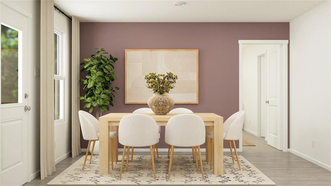 Dining room featuring light wood-type flooring and a healthy amount of sunlight