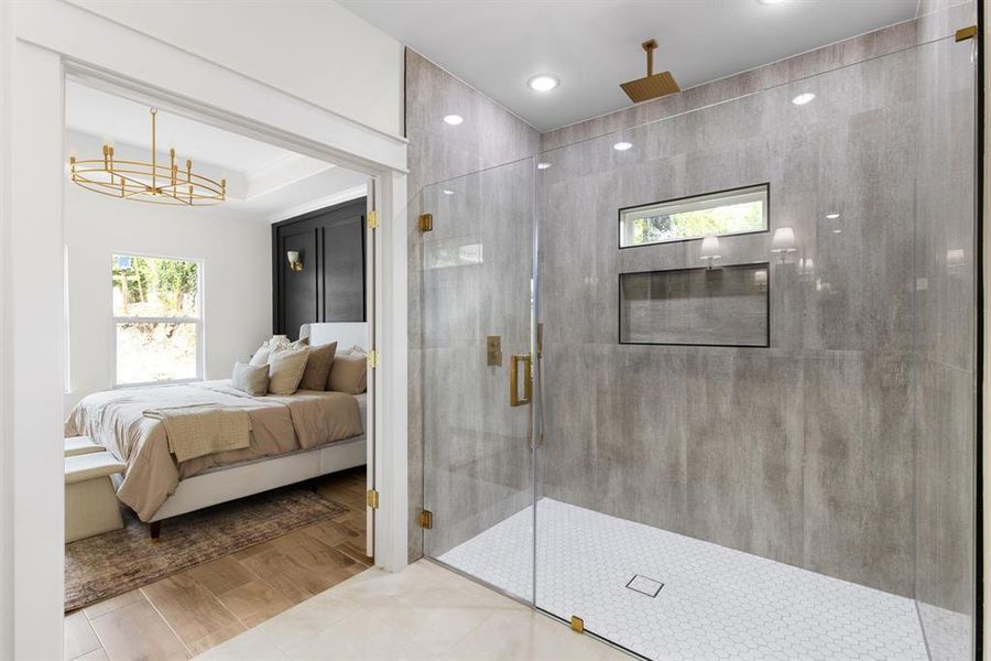 Bathroom with a shower with door and hardwood / wood-style flooring