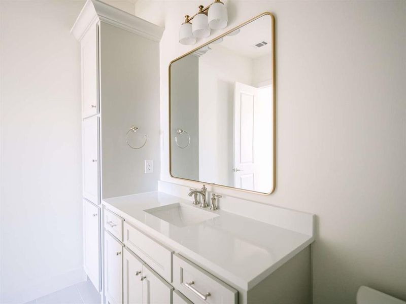 Bathroom featuring tile patterned flooring and vanity