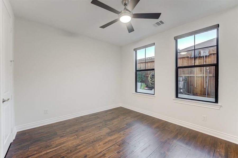 Another of the secondary bedrooms downstairs. Noticing the wood floors continue here.