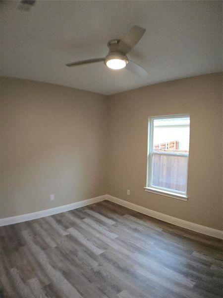 Unfurnished room featuring hardwood / wood-style floors and ceiling fan